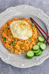  Nasi Goreng Indonesian Chicken Fried Rice with Fried Egg, Chili Sauce and Cucumber Top Down Photoc

