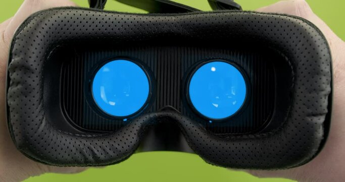 Person takes off glasses VR AR. Placeholder green screen blue screen