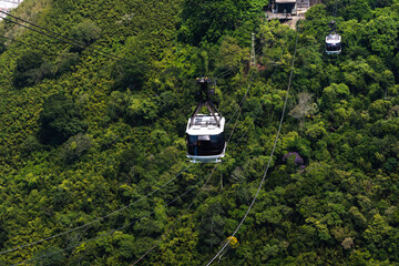 Sugarloaf cable car passing through Morro da Urca and Morro do Sugarloaf Mountain. Sunny morning