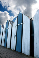 Fototapeta premium Strandhütten mit Wolken in Yport, Seine-Maritime, Normandie, Frankreich