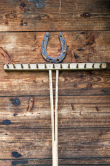 old horseshoe and rake on a wooden door