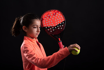 Girl playing paddle tennis on black background ready for play