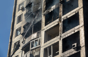 War in Ukraine. Firefighters on damaged residential building in Kyiv