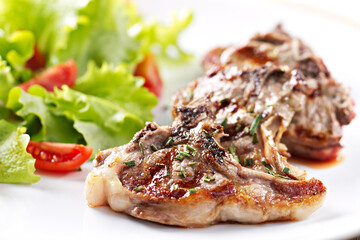 Grilled lamb chops with mixed salad. High quality photo