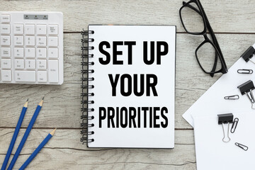 light working table and notepad with text . Set up your priorities