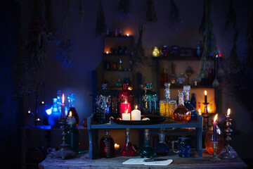 magic potions in witch's house with burning candles at night