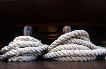 Wooden racks with spare ropes on an old wooden ship, close-up.