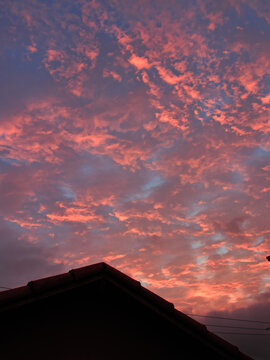 portrait format image of the silhouette of a roof, with a stupendous twilight sky in the background.
