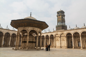 Fototapeta na wymiar The ablution fountain and the clock tower in Muhammad Ali mosque at Salah El-Din Al-Ayoubi citadel in Cairo, Egypt