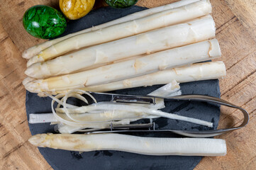Cooking of fresh white asparagus vegetables, peeler knife for asparagus