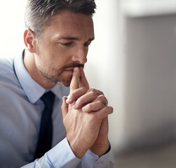 Hes got problems piling up. Cropped shot of a mature businessman looking anxious while working in his office.