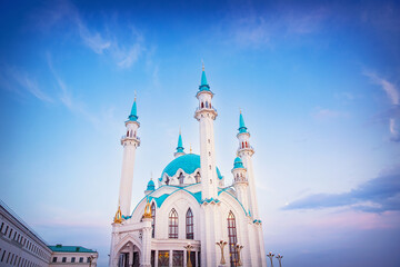 Beautiful white islamic mosque with blue roof sunset cloud with sun light