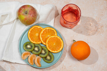 Orange, Kiwi and apple on the table
