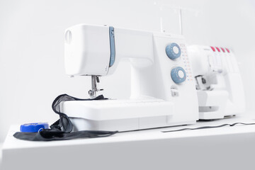 Sewing machine on table workshop of tailor white background