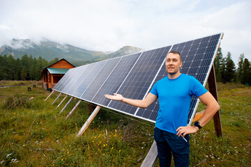Farmer man smiles and shows solar panels in country house in mountains, life in Iceland, Sweden,...