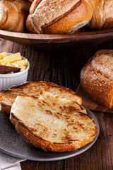 Naklejka premium French bread cut in half and toasted with butter.