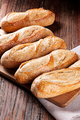 French baguettes on wooden board.