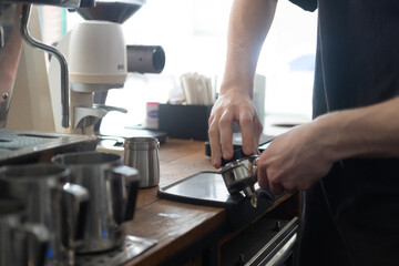 Barista Caucasian faceless make coffee. stage of preparation of a coffee drink 