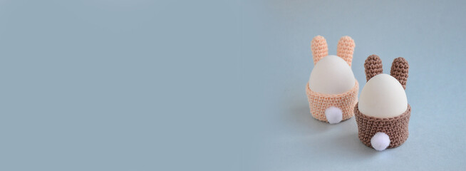 Easter holiday preparation. Crocheted egg basket in the shape of Easter bunny with a tail. Egg...