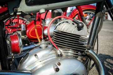 The detail of the polished old motorbike with the two stroke engine. The head has ribbing and is...