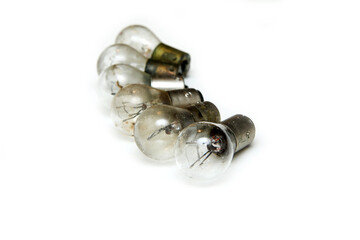 The small group of old shabby small bulbs for the car lights isolated in the white background. 