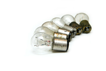 The small group of old shabby small bulbs for the car lights isolated in the white background. 