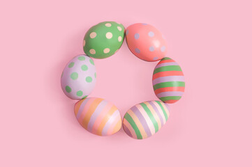 Fototapeta na wymiar decorative painted Easter eggs lie in a ring on a pink background. High quality photo