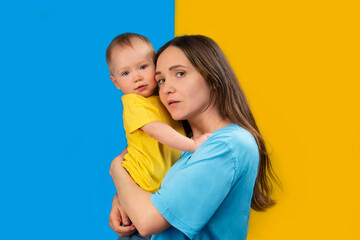YOUNG MOTHER WITH HER CHILD IN THE COLORS OF UKRAINE