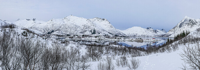 view to Norway village Henningsvaer,with snow capped mountains