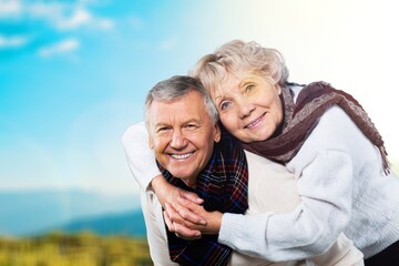 Happy active senior couple outdoors posing