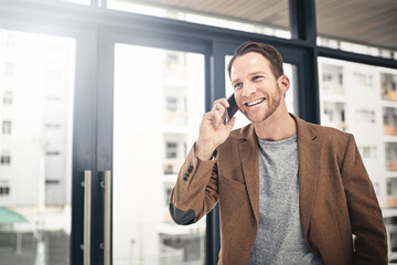 Opportunity is calling. Cropped shot of a businessman talking on his cellphone at the office.