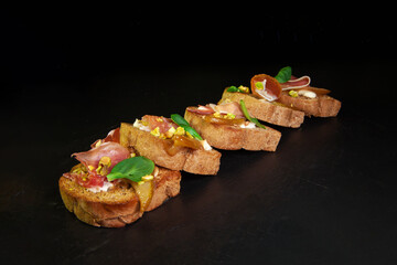 Whole grain bread sandwiches with ham, bacon, prosciutto, olives and olives