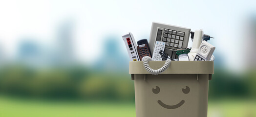 Smiling waste bin full of e-waste