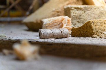 Jute thread lies on the floor near yellow glass wool