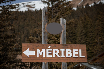 Sign for Meribel, a village in french alps, white letters on bro