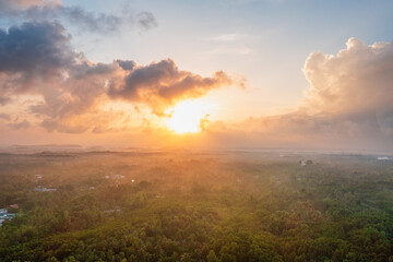 beautiful landscape panorama with the gold sky, clouds, and sunset. panoramic view of the sunrise, a new day. sun rays shine through clouds. ariel shot