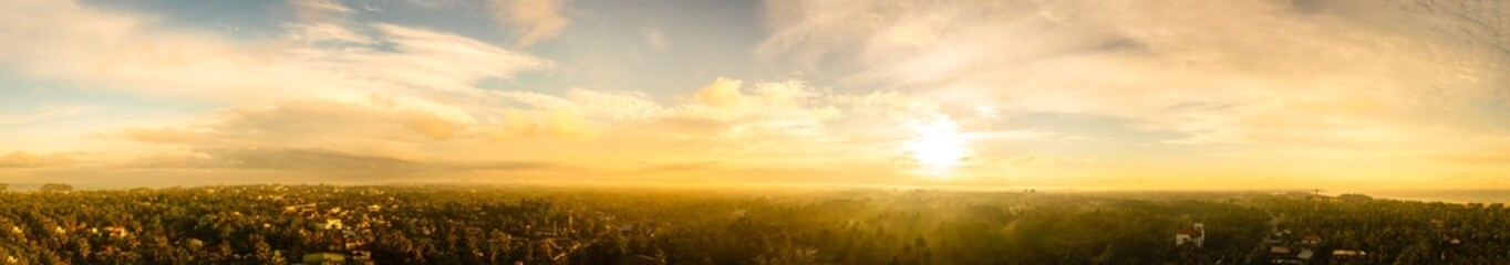 beautiful landscape panorama with the gold sky, clouds, and sunset. panoramic view of the sunrise, a new day. sun rays shine through clouds.