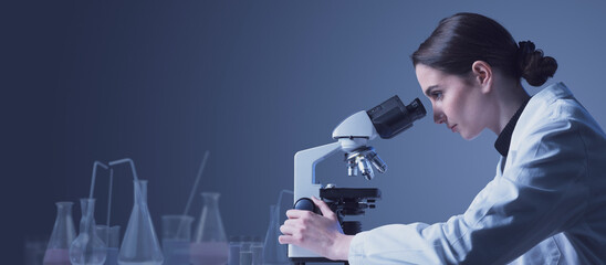 Woman using a microscope in the lab