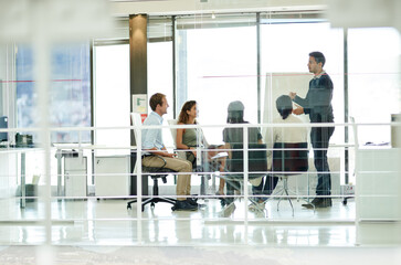 Lets hear everyones opinion. Shot of a group of colleagues brainstorming in an office.