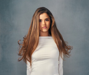 True beauty is owning who you are. Studio portrait of an attractive young woman posing against a grey background.