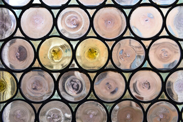 Stained glass window in a medieval castle. Round glass pattern. 