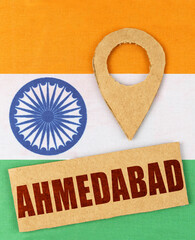On the Indian flag, a geolocation symbol and a sign with the inscription - Ahmedabad