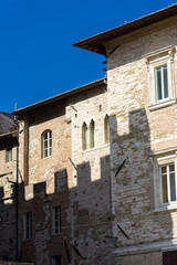 Fototapeta na wymiar Shadow of Palazzo dei Priori on a medieval building in the historicc center of Perugia, Umbria Italy