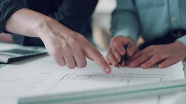 Video of close-up of smart architects holding pen over diagram on paper in the office.