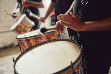 Sounds that come straight out of Brazil. Closeup shot of a musical performer playing drums with his band.