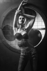 a young attractive girl poses in the background in an industrial style