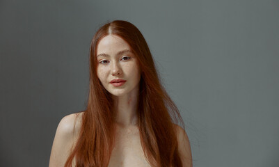 Charming redhead young girl with naked shoulders, long ginger hair. Natural beauty, skin and hair...