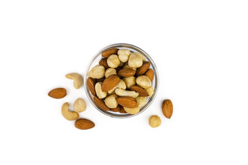 Mix of nuts in a glass bowl isolated on white background. Top view. Healthy food. Banner. Close-up.