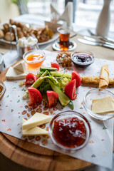 Traditional Turkish breakfast. Turkish tea, honey, cheese, jam, cucumber, tomatoes, butter. 