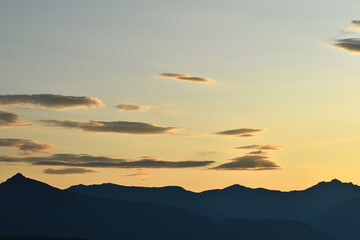 dawn or dusk in the alps with the silhouette of mountains and copy space